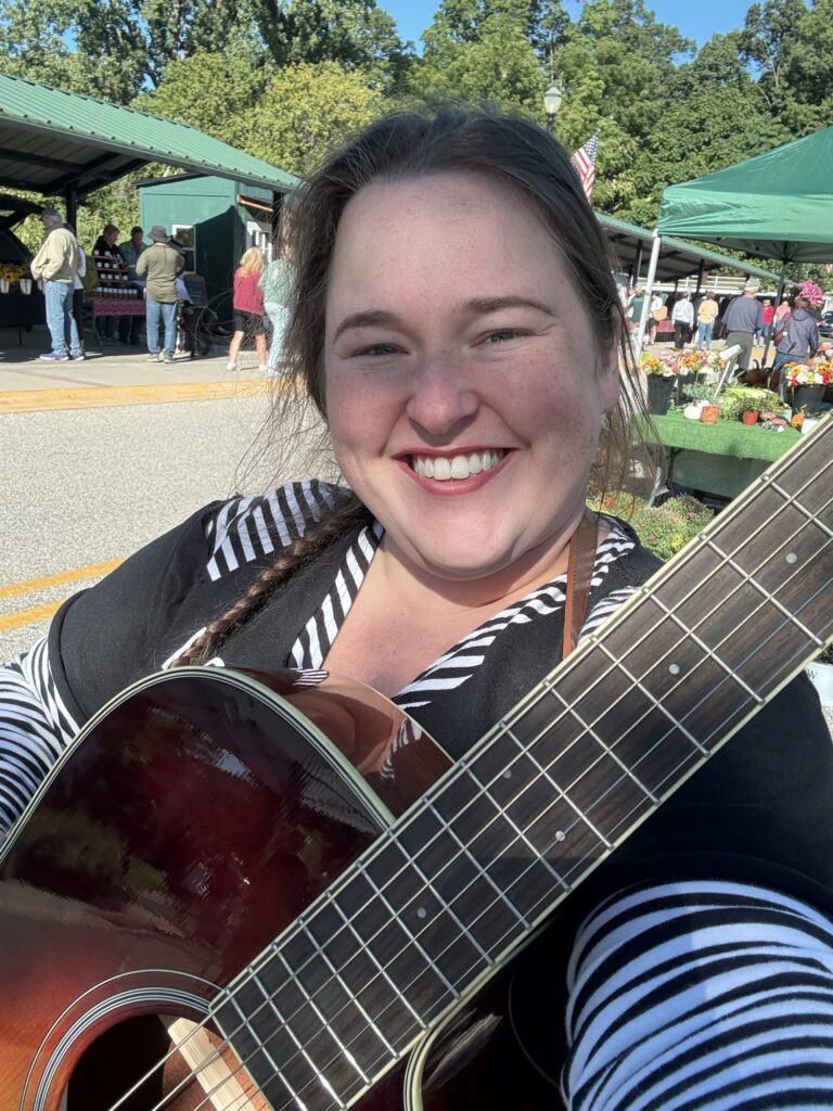 Bobbie JoEle performing acoustic at a farmer's market